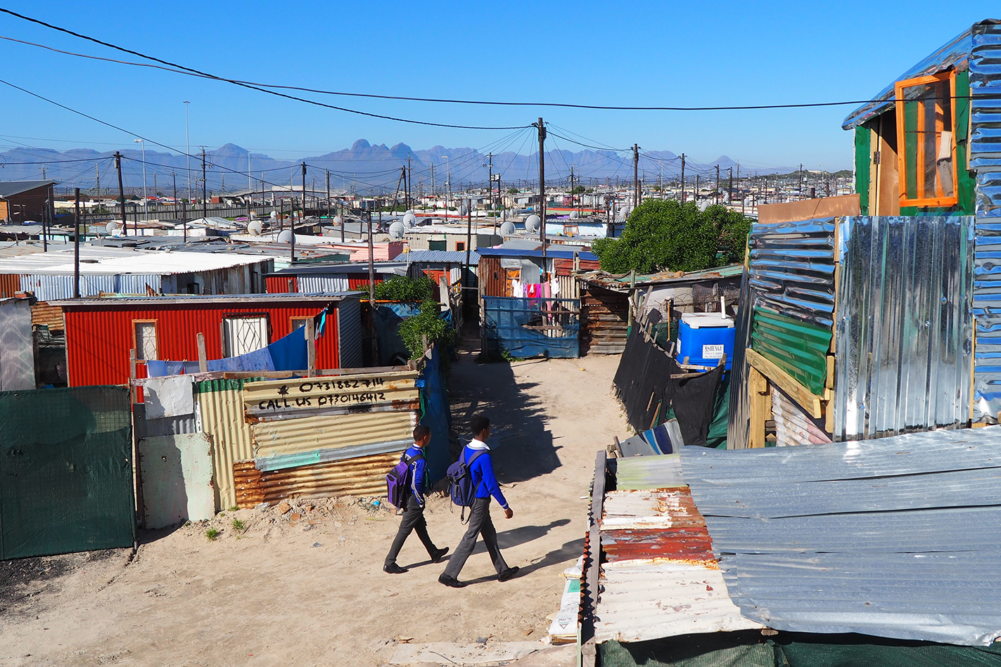 Two students walking home from school in township in Cape Town South Africa